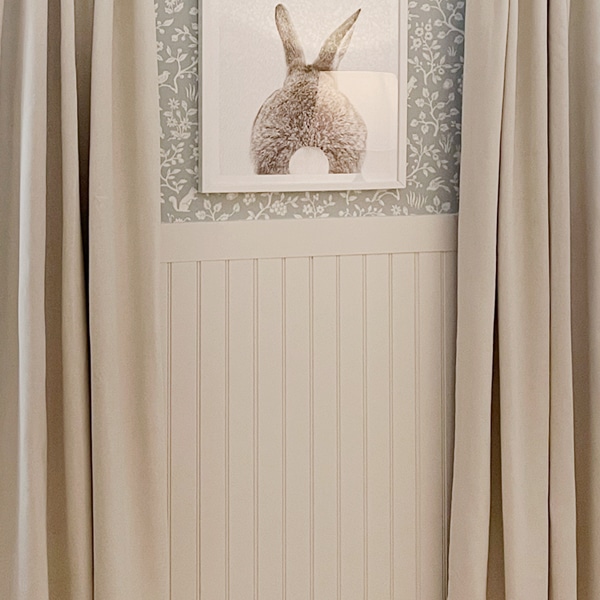 beadboard wainscoting with bunny photo above and curtains on sides