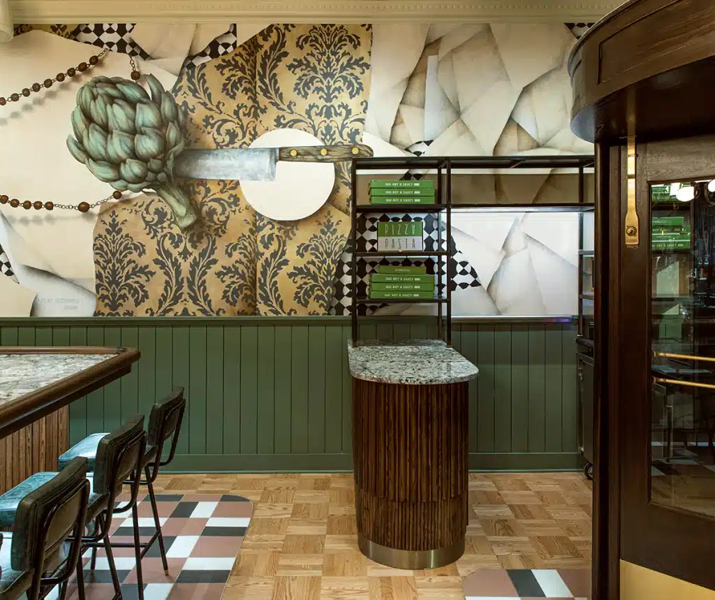 Entrance area to restaurant. Hostess desk with green nickel gap wainscoting in the background.