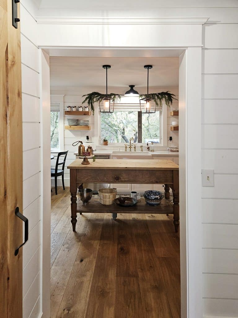 View through craftsman doorway into farmhouse style kitchen