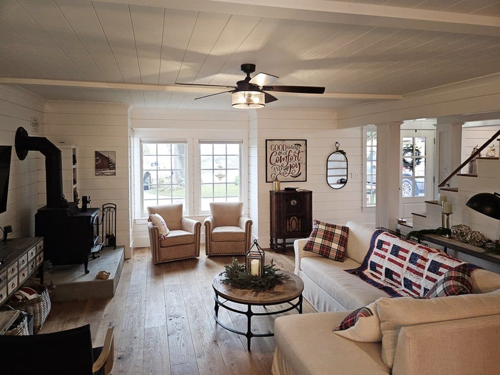 Farmhouse living room with shiplap walls and v-groove ceiling