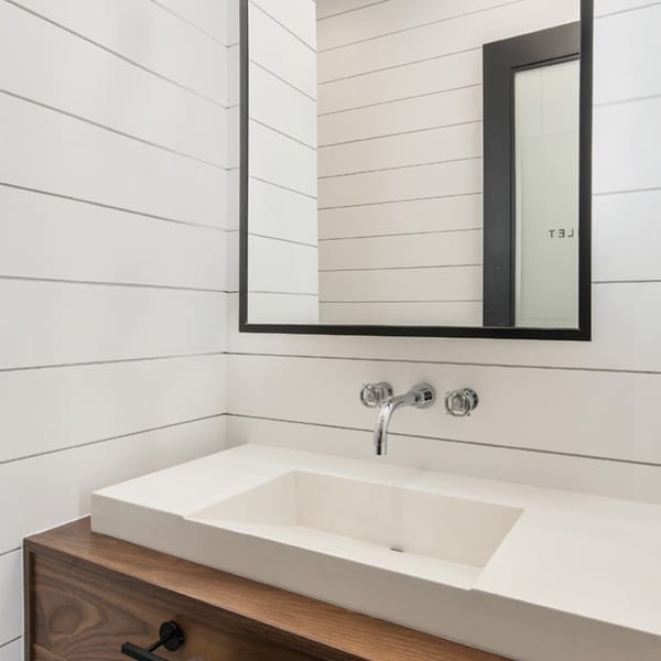 Modern shiplap powder room with rectangle mirror minimalist sink and stain grade vanity