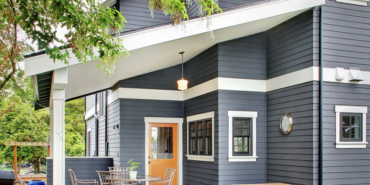 Back covered deck area of blue house with bright white WindsorONE trim