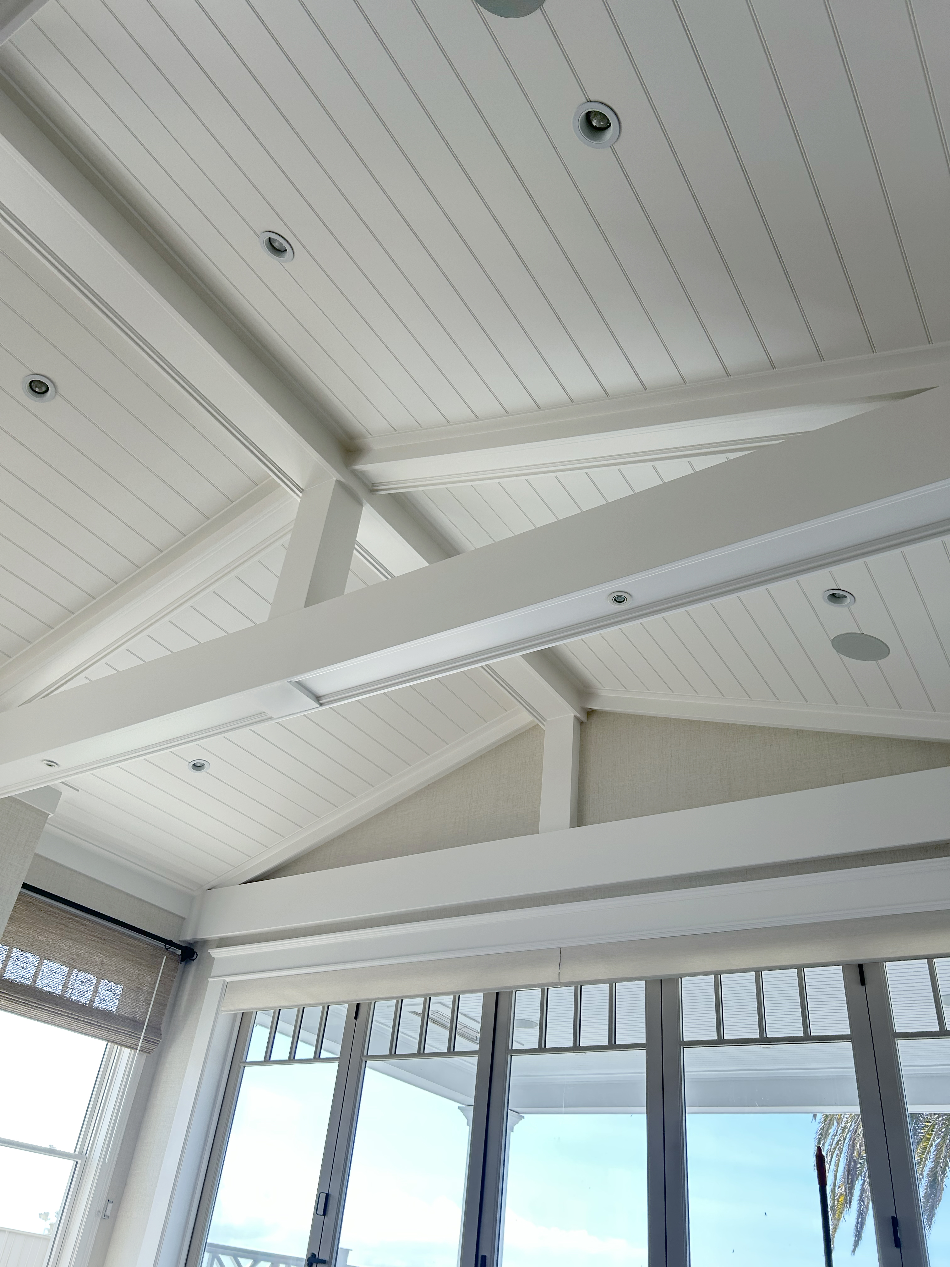 Vaulted ceiling with tongue and groove boards and wrapped beams