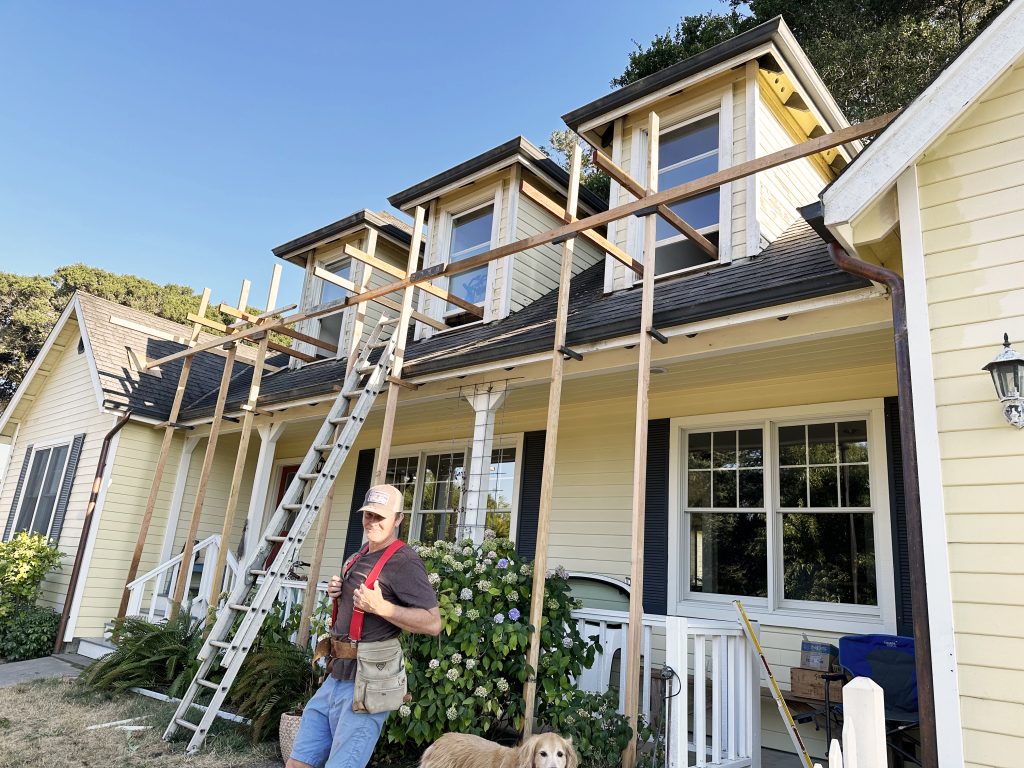 Stig in front of house with scaffolding setup started