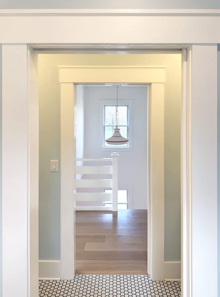 Looking though door way to another door both cased in simple craftsman trim, hall in background