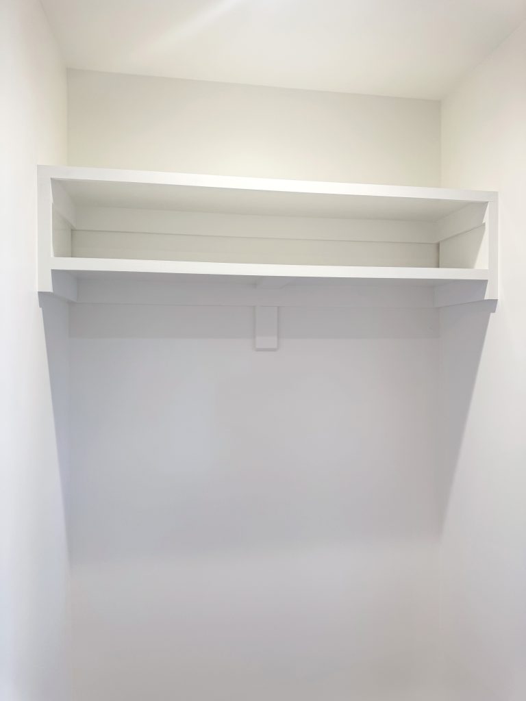Empty clothes closet with double shelf cubby