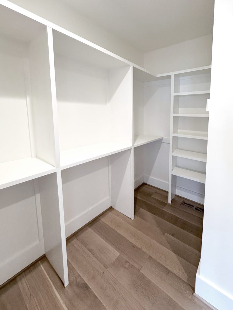 Large custom closet with large hanging storage and smaller shelves
