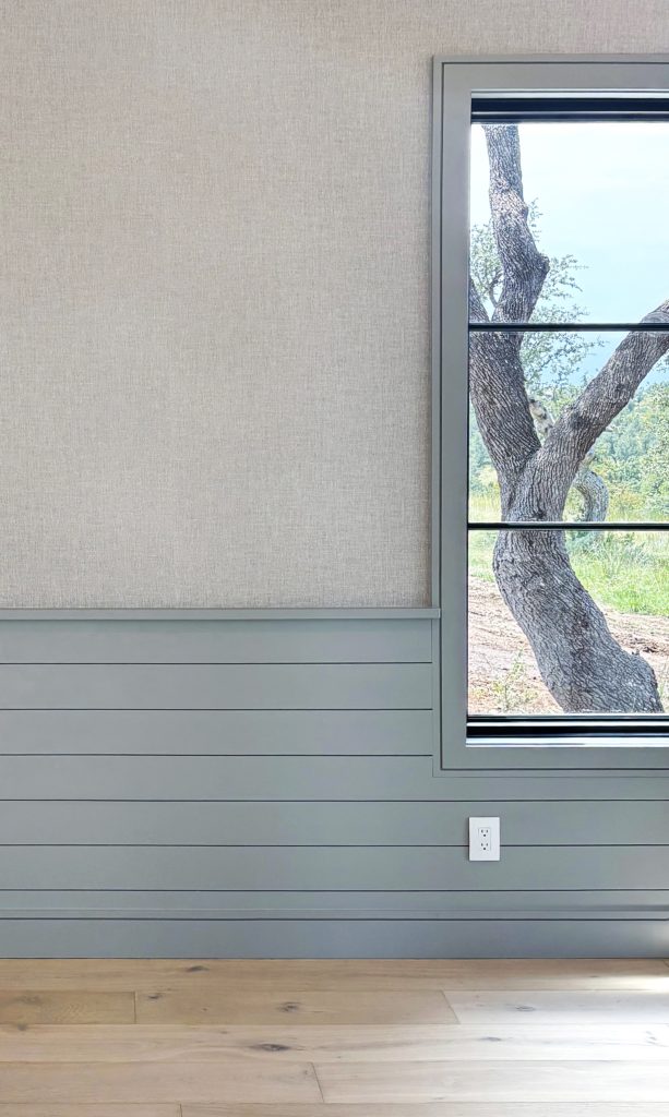 Window casing and horizontal shiplap wainscoting painted green gray color