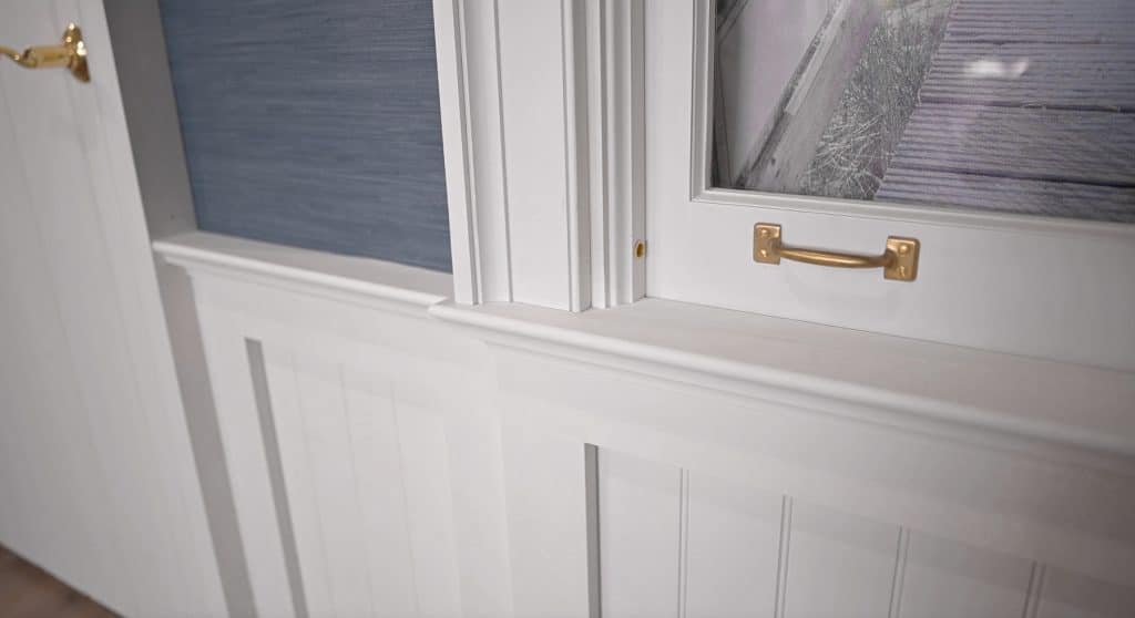 Detail of where window casing meets wainscot cap & window sill
