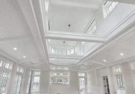View of ceiling of natatorium indoor pool space with ceiling and ample windows