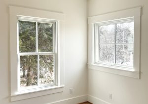 2 windows in the corner of the room, nice natural light, simple craftsman farmhouse moldings